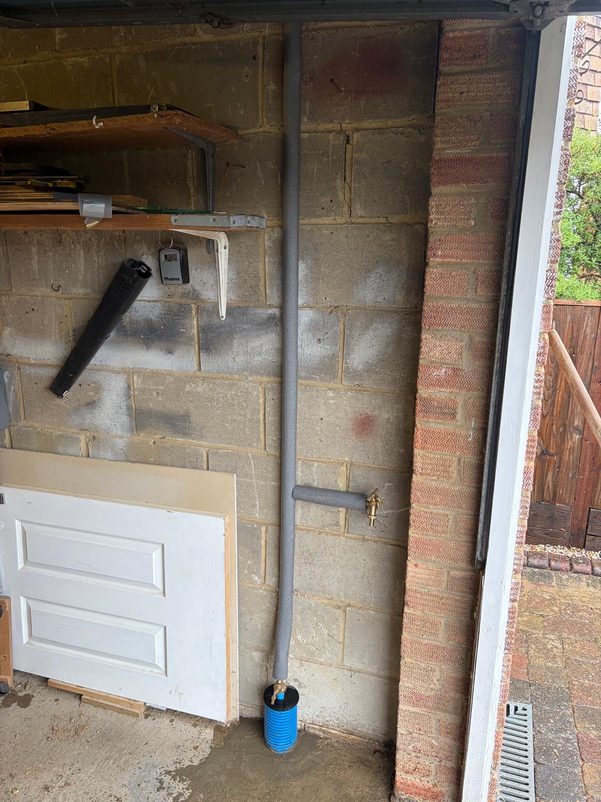 New water supply pipe connection at an East Grinstead property, insulated with an outside tap fitted.