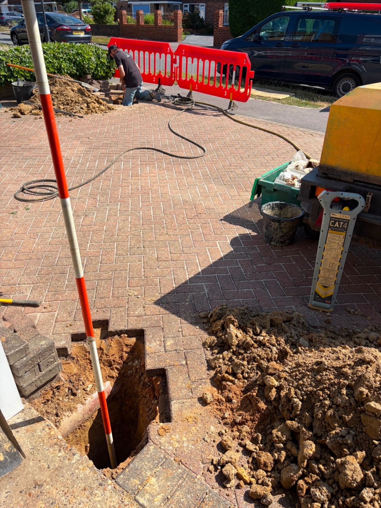 CAT4 cable avoidance tool and initial pit setup on a Sussex driveway before excavation.