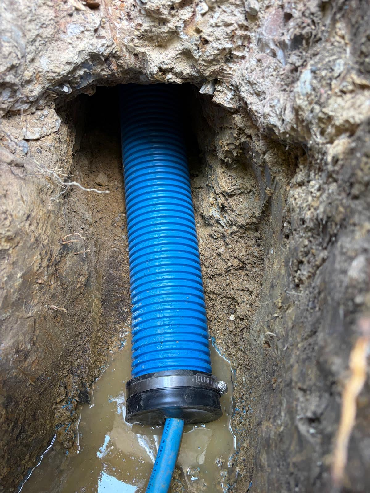 New 32mm MDPE water supply pipe entering property through protective duct.