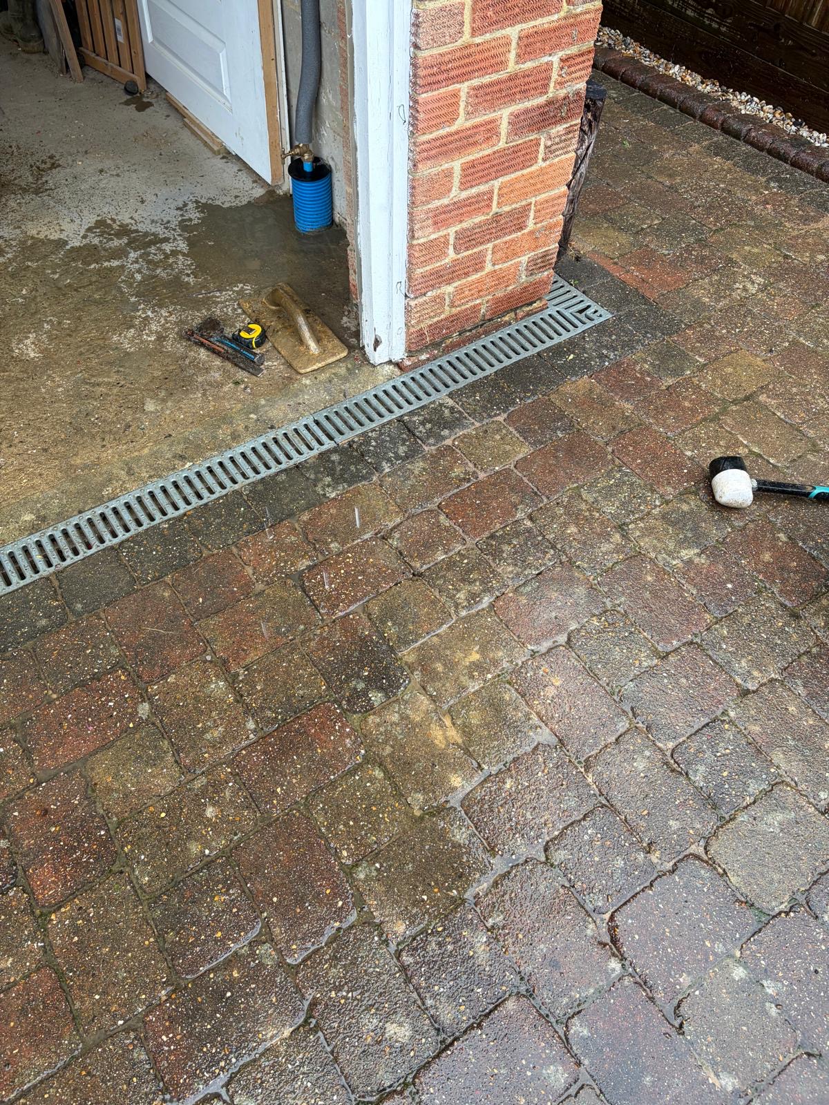 Block paving reinstated at the property entrance after water main replacement in East Grinstead.