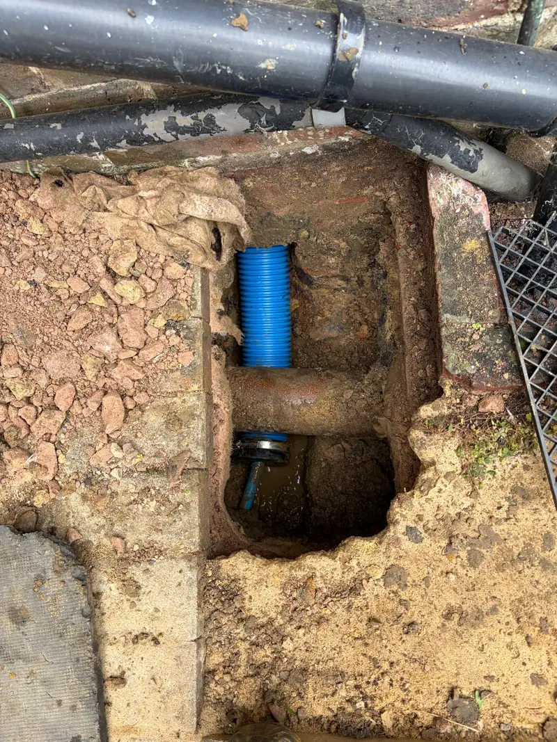 Blue duct at the external entry point for the water supply pipe.