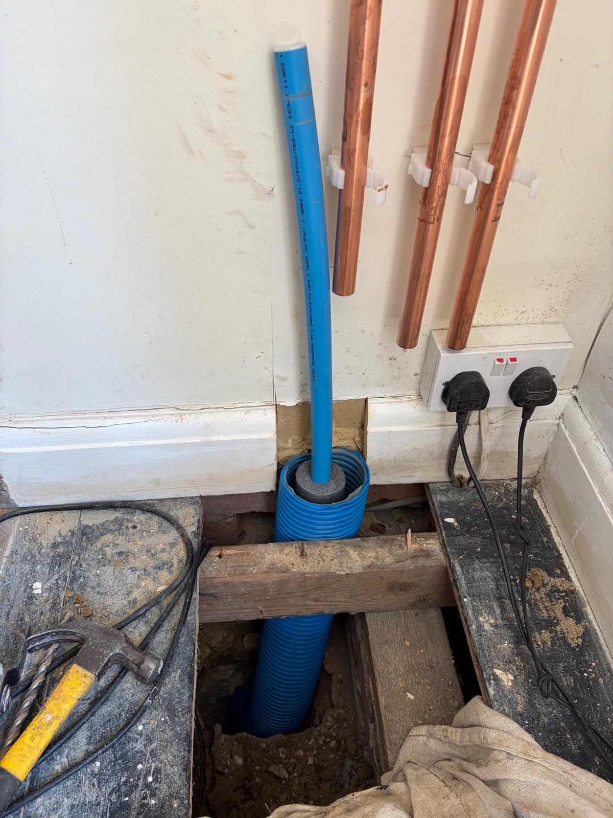 New external stop tap and lagged pipework on the outside wall of a Sussex home.