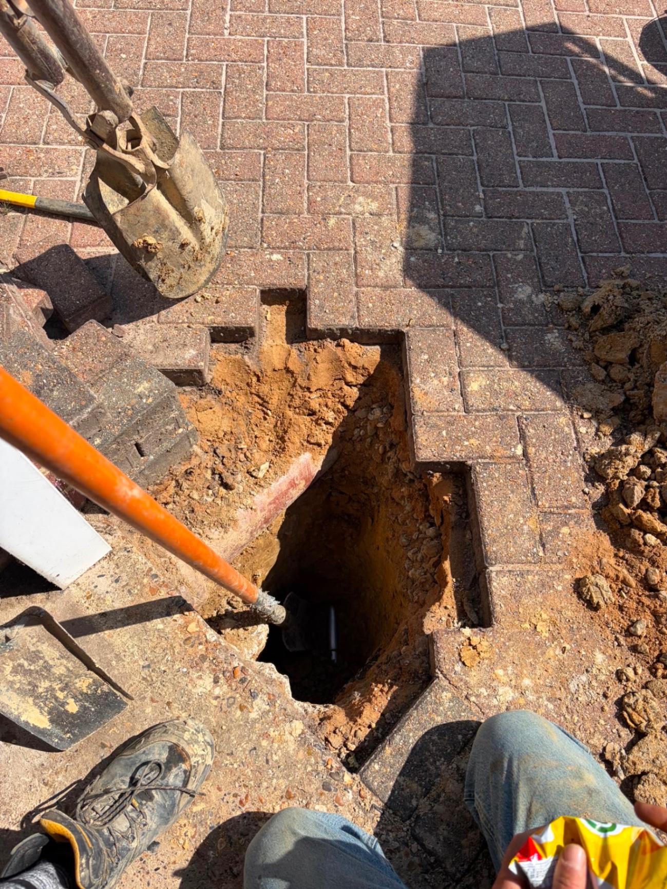Underground water main excavation through block paving, Crawley