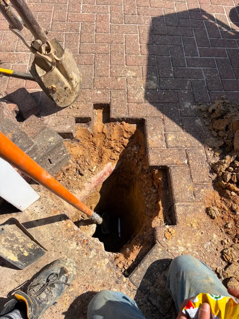 Underground water main excavation through block paving, Crawley