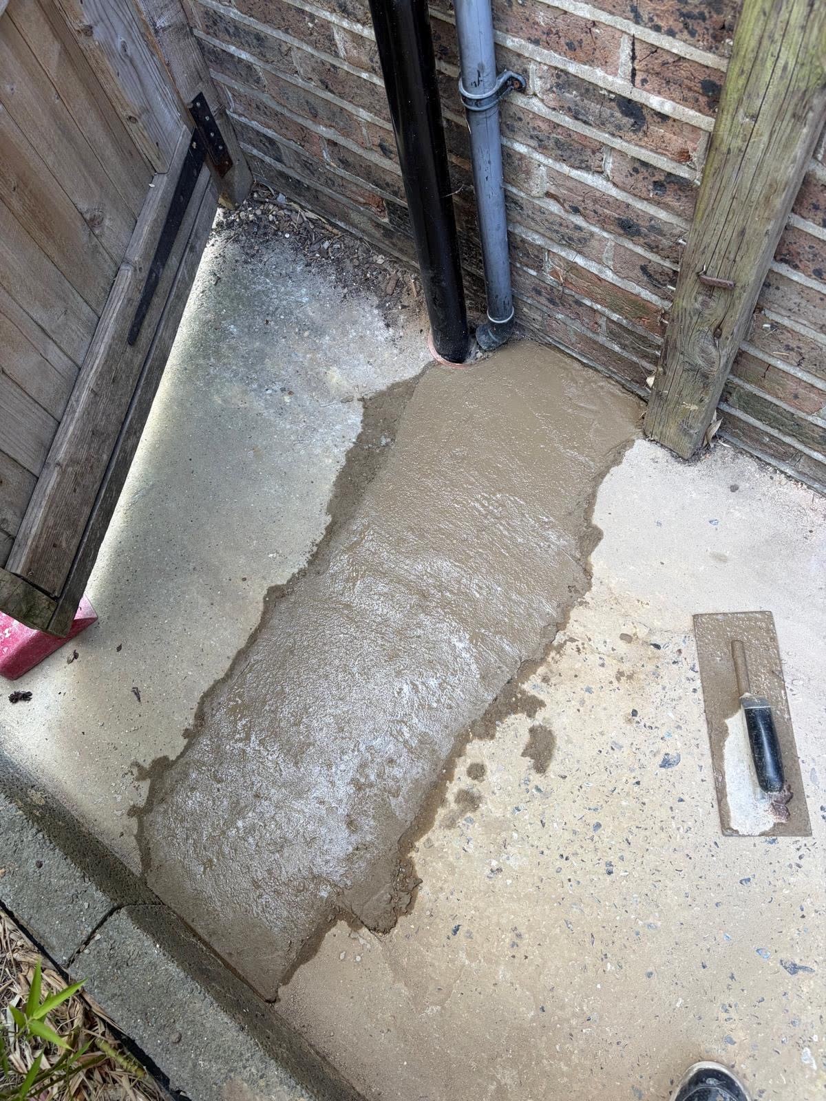 Concrete reinstated after underground water main replacement.